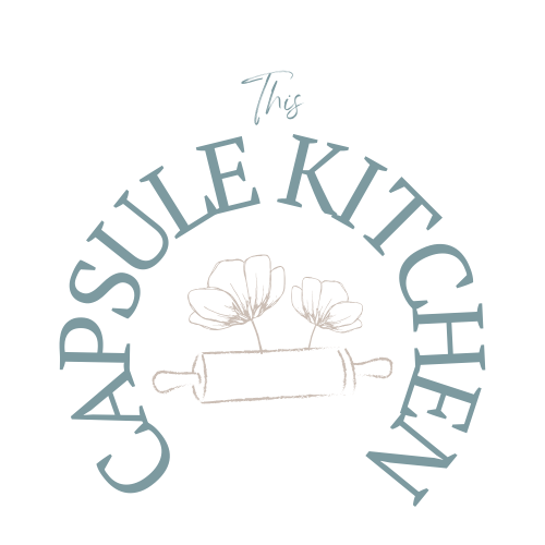 This Capsule Kitchen logo with rolling pin and flowers in the middle of the text